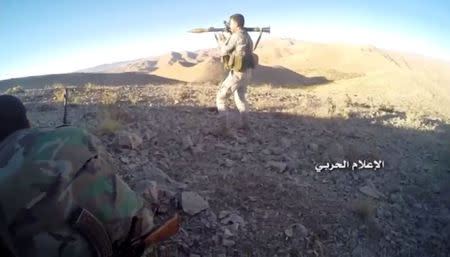 A still image taken on August 19, 2017 from a footage of Hezbollah military handout shows a Hezbollah fighter holding an RPG at western Qalamoun, Syria. Hezbollah Military Handout via Reuters TV.