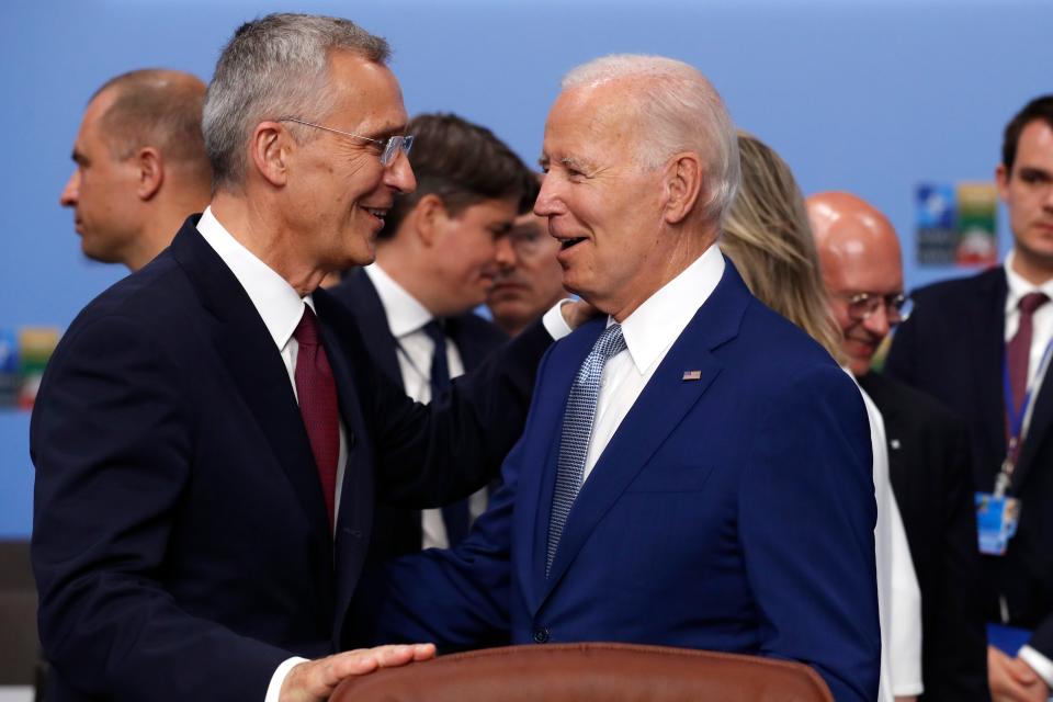NATO Secretary General Jens Stoltenberg, left, speaks with United States President Joe Biden on Tuesday during a round table meeting of the North Atlantic Council during a NATO summit in Vilnius, Lithuania.