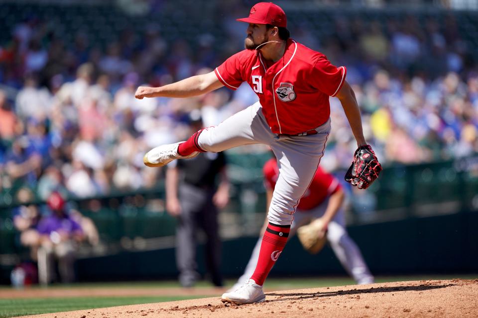 Cincinnati Reds non-roster invitee pitcher Graham Ashcraft follows through on a delivery during a spring training game against the Chicago Cubs, Monday, March 21, 2022, at Sloan Park in Mesa, Ariz.