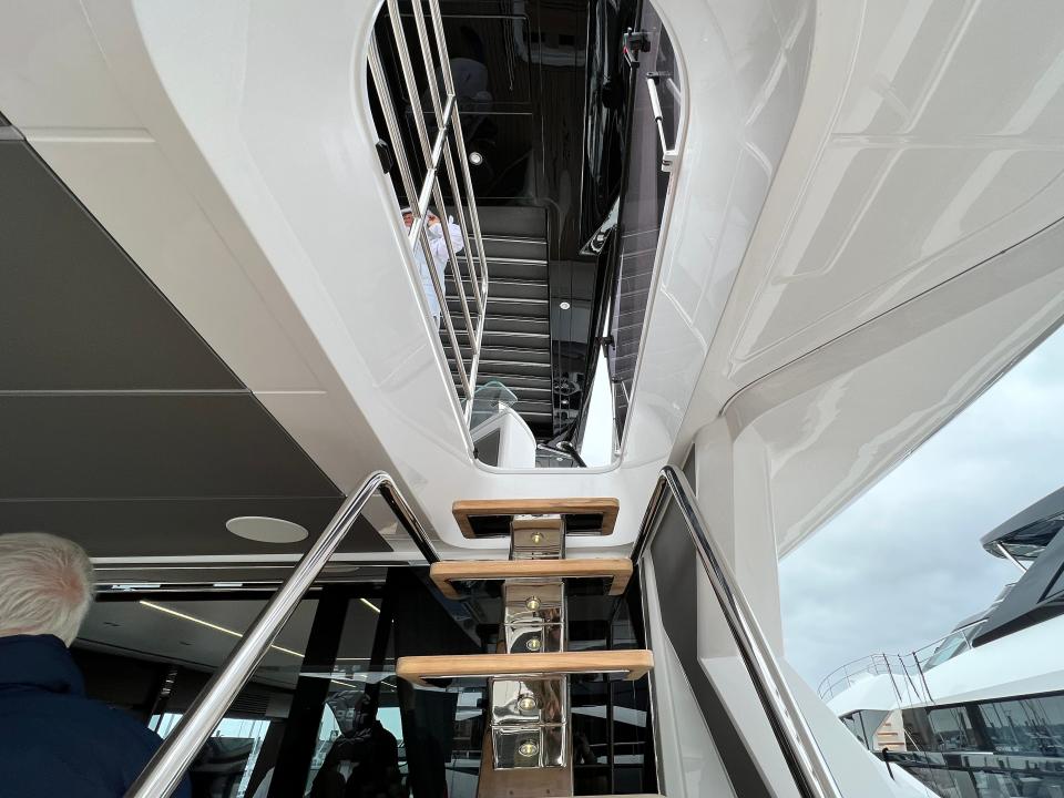 A narrow staircase leading up to the flybridge on a Sunseeker 76