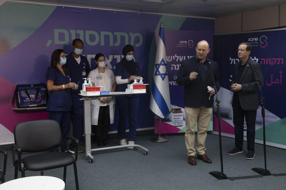 Israeli Prime Minister Naftali Bennett, front left, speaks to journalists with President Isaac Herzog, who received a third coronavirus vaccine at the Sheba Medical Center in Ramat Gan, Israel, Friday, July 30, 2021.(AP Photo/Maya Alleruzzo, Pool)