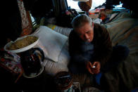 Homeless Makoto Shinbo smokes a cigarette at his makeshift house in Miyashita park in Tokyo, Japan, February 17, 2017. REUTERS/Kim Kyung-Hoon