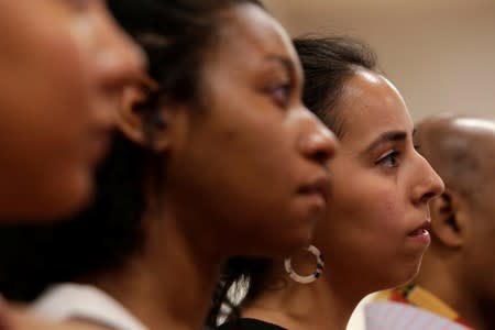 Constituents listen to Representative Alexandria Ocasio-Cortez speak during an Immigration Town Hall at The Nancy DeBenedittis Public School in Queens