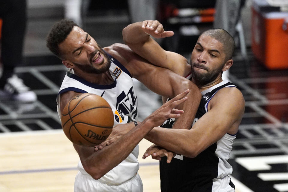 Utah Jazz center Rudy Gobert, left, blocks a pass intended for Los Angeles Clippers forward Nicolas Batum during the second half of Game 3 of a second-round NBA basketball playoff series Saturday, June 12, 2021, in Los Angeles. (AP Photo/Mark J. Terrill)