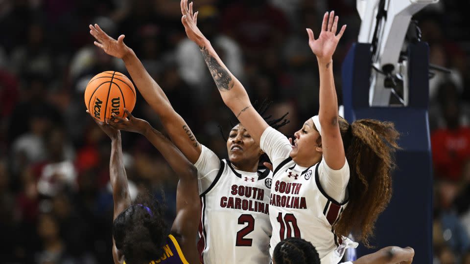 Watkins (#2) and Cardoso (#10) block a shot attempt by LSU's Flau'jae Johnson. - Eakin Howard/Getty Images