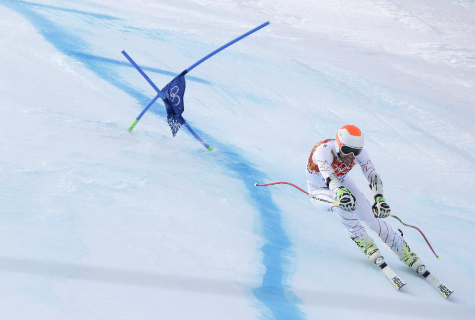 Joint bronze medal winner Bode Miller of the United States passes a gate in the men's super-G the Sochi 2014 Winter Olympics, Sunday, Feb. 16, 2014, in Krasnaya Polyana, Russia. (AP Photo/Charlie Riedel)