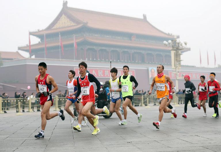 Runners take part in the 34th Beijing International Marathon which began at Tiananmen Square in Beijing on October 19, 2014