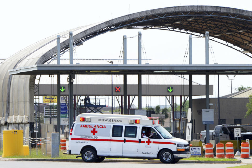 A Mexican Red Cross ambulance transports two Americans found alive after their abduction in Mexico last week to a Brownsville Fire Department EMS Ambulances through Veterans International Bridge at Los Tomates in Brownsville, Texas, Tuesday, March 7, 2023. A road trip to Mexico for cosmetic surgery ended with two Americans dead — and two others found alive in a rural area near the Gulf coast — after a violent shootout and abduction that was captured on video, officials said Tuesday. (Miguel Roberts/The Brownsville Herald via AP)