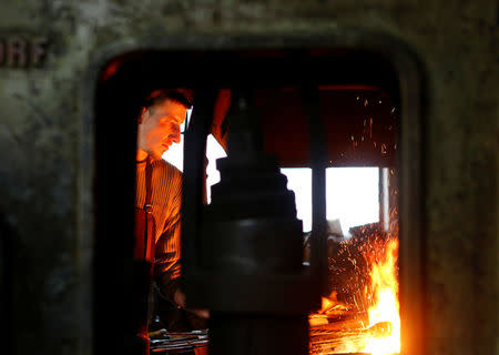 Blacksmith Johann Schmidberger works on a suit of armour for the Vatican's Swiss Guards at his workshop in Molln, Austria, March 29, 2017. Picture taken March 29, 2017. REUTERS/Leonhard Foeger