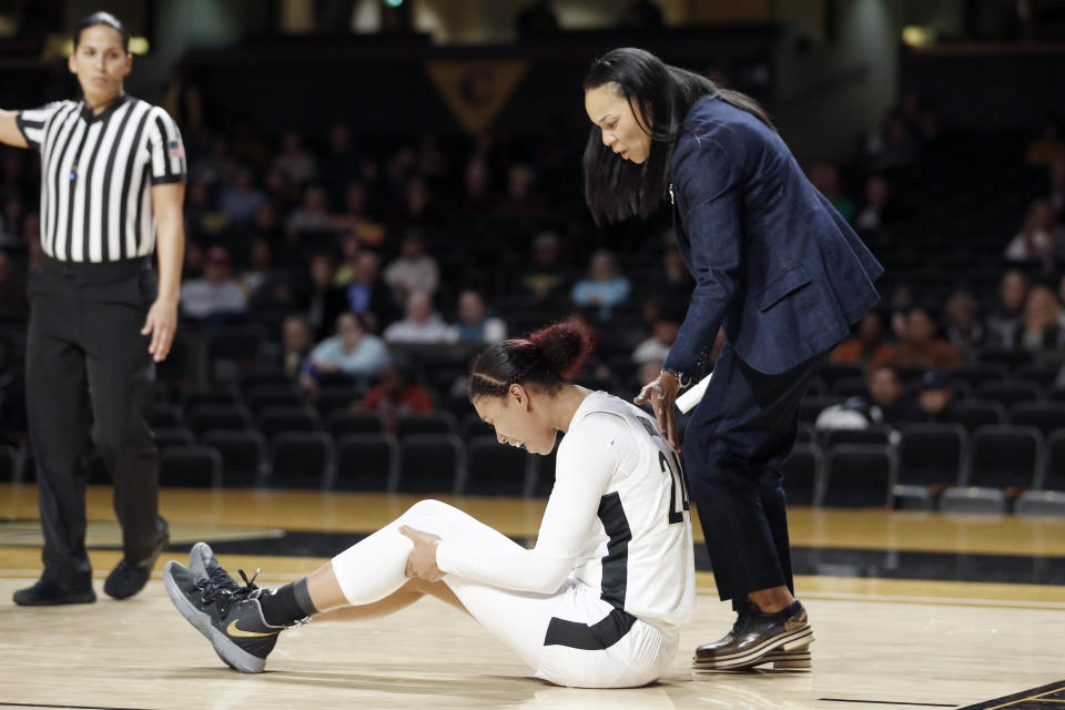 South Carolina head coach Dawn Staley, right, checks on Vanderbilt forward Autumn Newby (24) after Newby was injured during the second half of an NCAA college basketball game Sunday, Jan. 12, 2020, in Nashville, Tenn. South Carolina won 93-57. (AP Photo/Mark Humphrey)