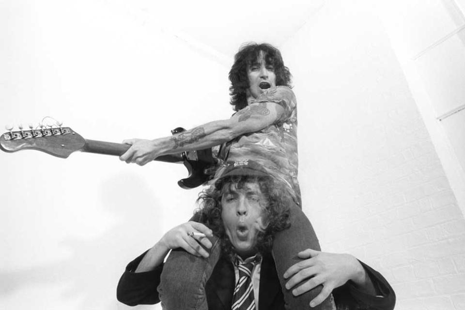 Bon Scott on Angus Young's shoulders