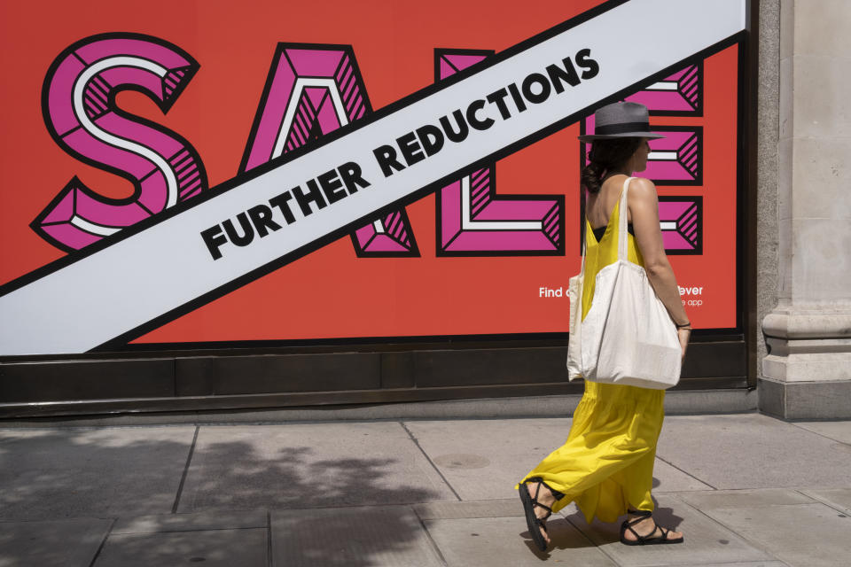 A shopper walks past Selfridges whose Summer Sale is advertised in their window banners on Oxford Street in the West End on Covid 'Freedom Day'. This date is what Prime Minister Boris Johnson's UK government has set as the end of strict Covid pandemic social distancing conditions with the end of mandatory face coverings in shops and public transport, on 19th July 2021, in London, England. (Photo by Richard Baker / In Pictures via Getty Images)