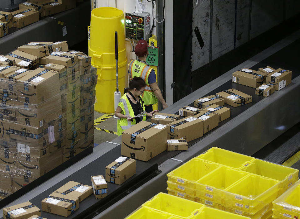 FILE - In this Feb. 9, 2018, file photo, packages move down a conveyor system were they are directed to the proper shipping area at an Amazon Fulfillment Center in Sacramento, Calif. California becomes the first U.S. state to bar warehouse retailers, like Amazon, from firing workers for missing quotas that interfere with bathroom and rest breaks. (AP Photo/Rich Pedroncelli, File)
