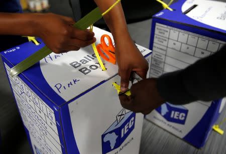 Election officials seal ballot boxes at the end of voting in South Africa's parliamentary and provincial elections at a polling station in Johannesburg, South Africa, May 8,2019. REUTERS/Philimon Bulawayo