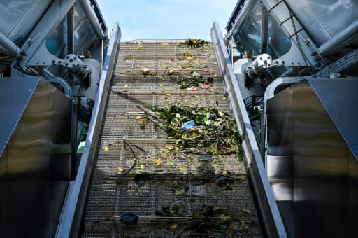 Trash collected by the Interceptor barge rolls up a conveyor belt before being dropped into dumpsters