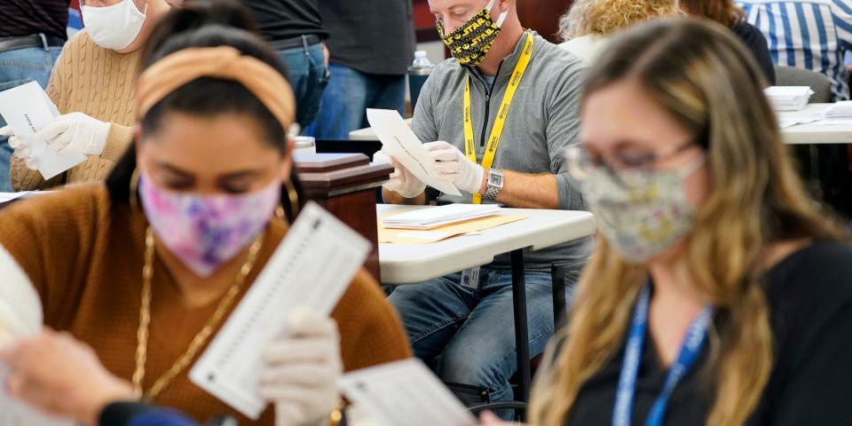 Municipal workers extract Luzerne County ballots from their envelopes, in Wilkes-Barre, P