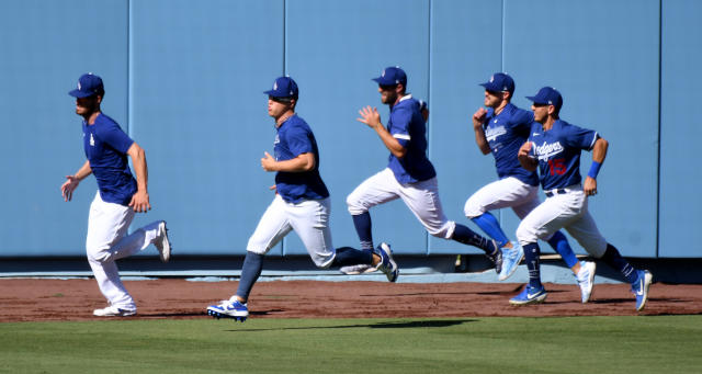 LOS ANGELES, CA - JULY 03:  Los Angeles Dodgers center fielder Cody Bellinger, left, and teammates runs in the outfield during the Los Angeles Dodgers first summer camp workout in preparation for the 2020 season due to the Coronavirus Pandemic in Los Angeles on Friday, July 3, 2020. (Photo by Keith Birmingham/MediaNews Group/Pasadena Star-News via Getty Images)