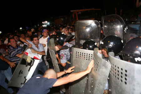 Riot police clash with demonstrators who had gathered in a show of support for gunmen holding several hostages in a police station in Yerevan, Armenia, July 20, 2016. Picture taken July 20, 2016. Hrant Khachatryan/PAN Photo/Handout via REUTERS