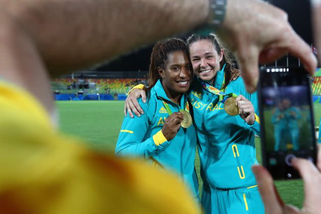 Ellia Green, left, of Australia celebrates winning a gold medal with teammate Chloe Dalton in the Women's Rugby Sevens at the Rio Olympics in 2016. (Photo: Alexander Hassenstein via Getty Images)