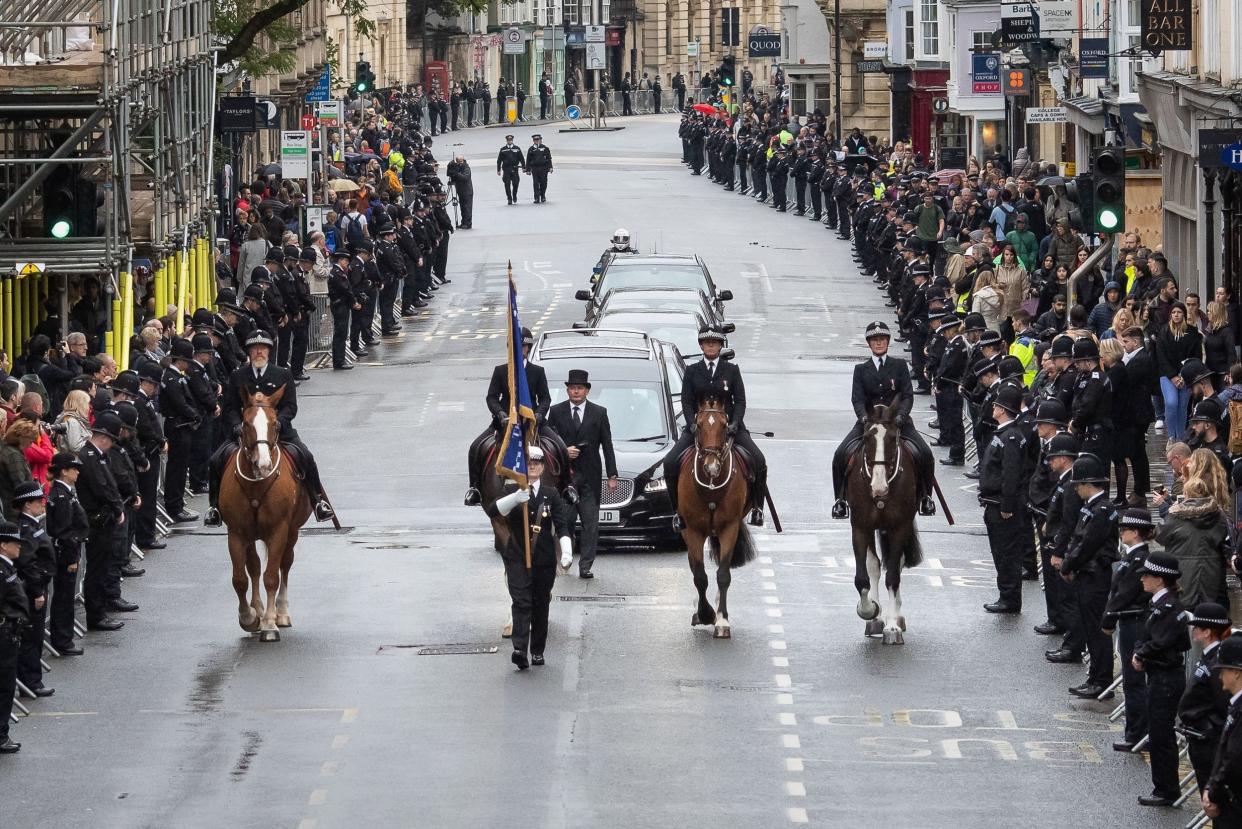 People line the High Street in Oxford to pay their respects as the funeral cortege for Pc Andrew Harper: PA