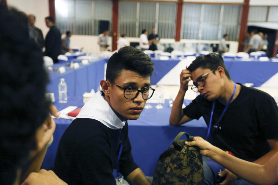 FILE - Student leader Lesther Aleman sits with his fellow students at the end of the second day of a national dialogue, in Managua, Nicaragua, May 18, 2018. Aleman, who confronted President Daniel Ortega and urged him to "surrender" during the 2018 social uprising, was sentenced to 13 years in prison on Thursday, Feb. 10, 2022. (AP Photo/Alfredo Zuniga, File)