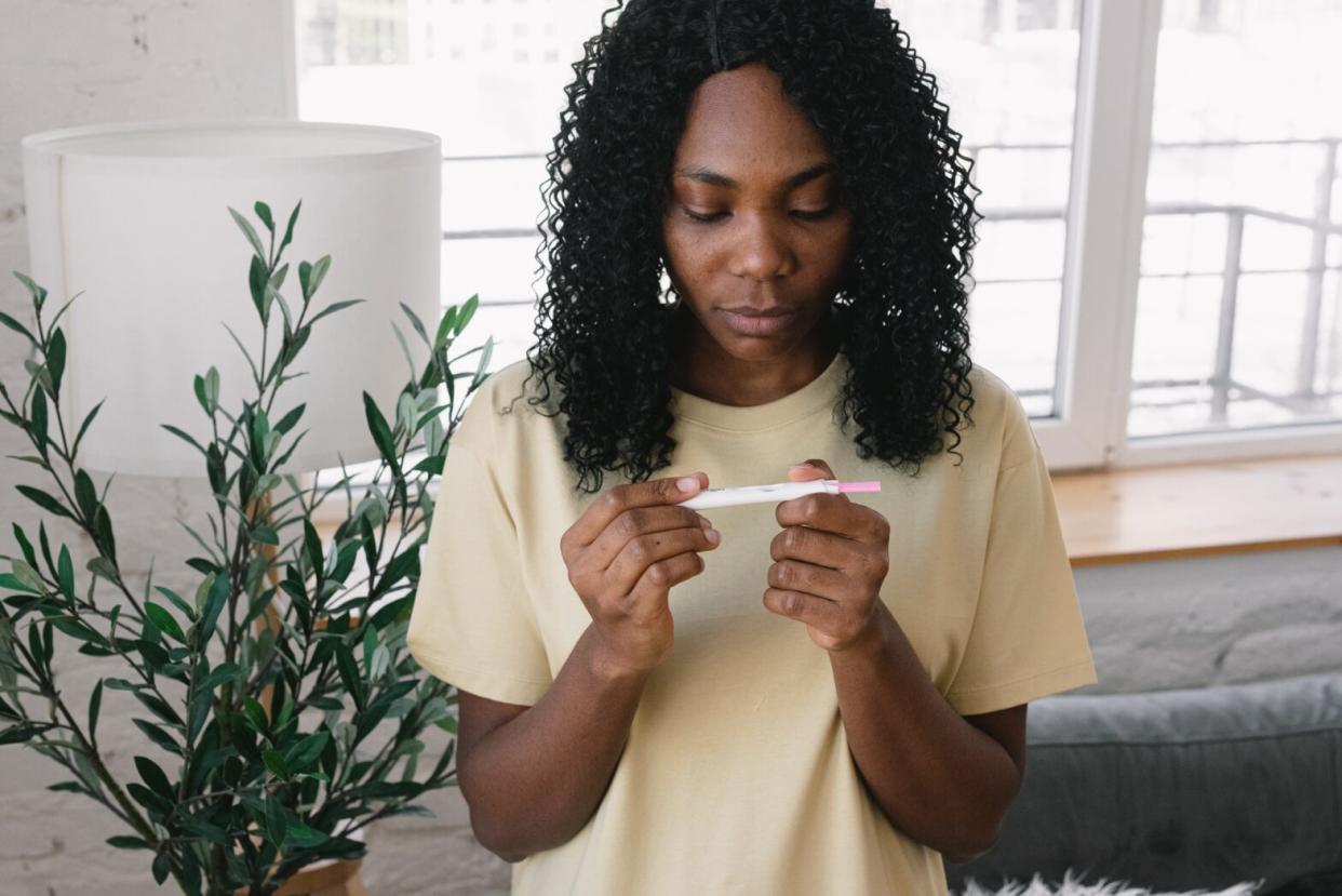 black woman holding pregnancy test