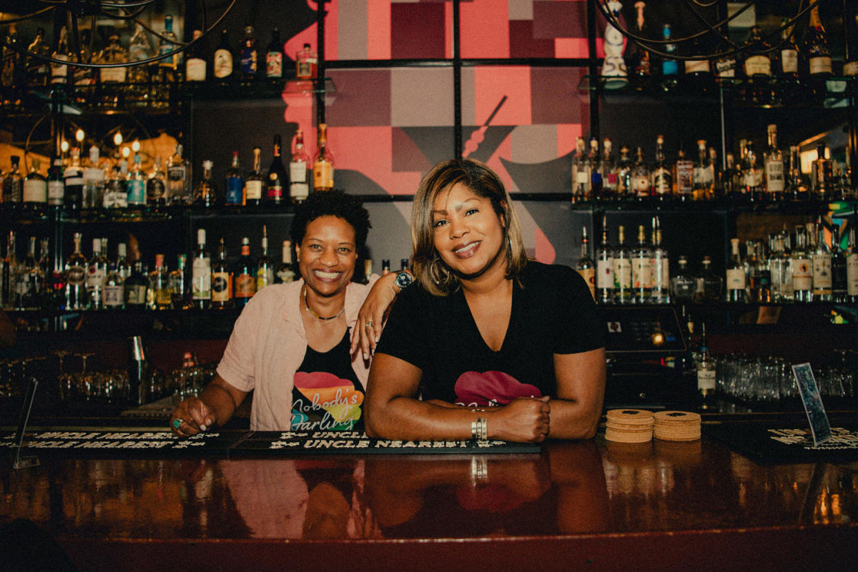 Angela Barnes and Renauda Riddle pose for a photo behind the bar. (Akilah Townsend for NBC News)