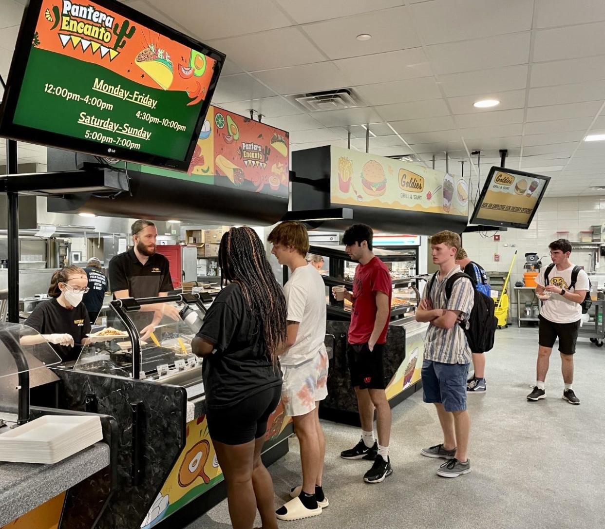 UW-Milwaukee students wait in line for food at Sandburg Cafe on Tuesday. The university is facing a student worker shortage.