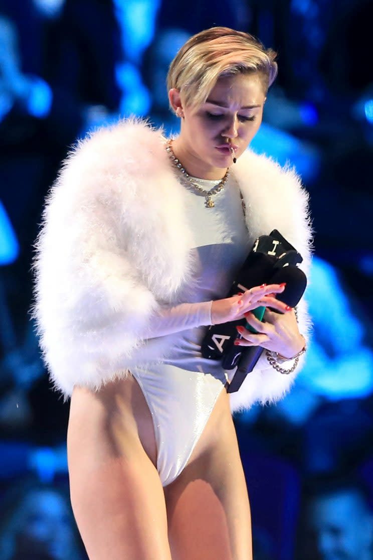 Miley Cyrus smokes onstage at the MTV Europe Music Awards after winning Video of the Year.