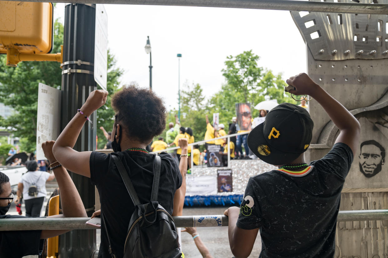 People watch a parade taking place to celebrate Juneteenth on June 19, 2021 in Atlanta, Georgia. (Photo by Megan Varner/Getty Images)