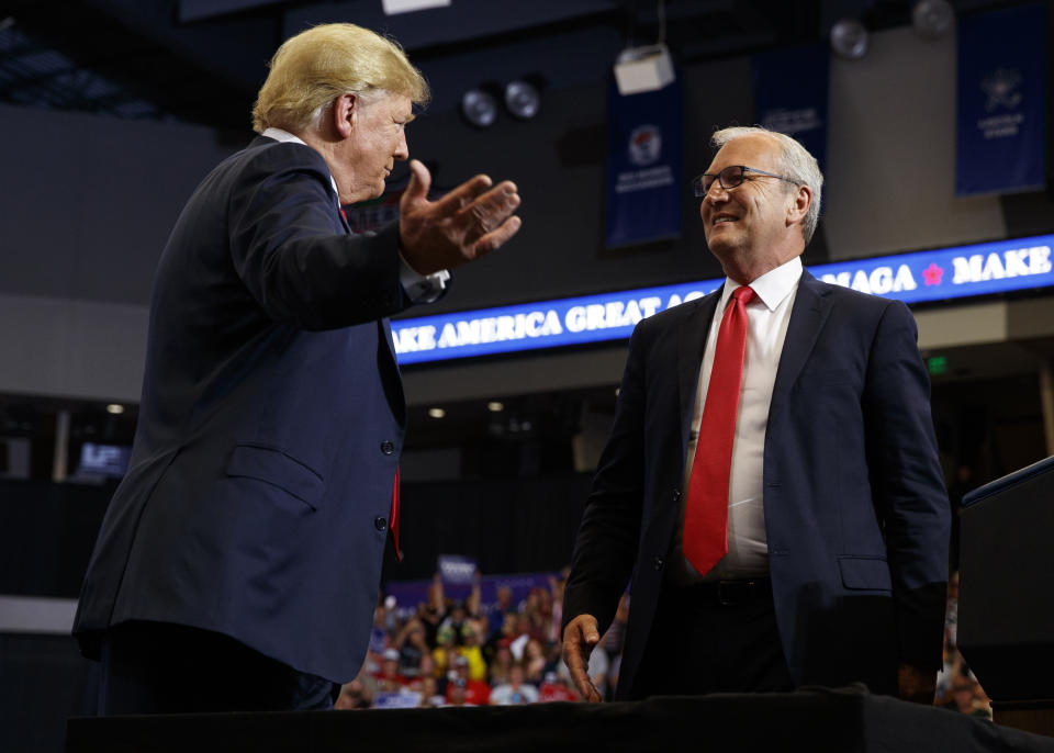 FILE - In this June 27, 2018, file photo President Donald Trump hugs Senate candidate Rep. Kevin Cramer, R-N.D., during a campaign rally in Fargo, N.D. The conservative Koch brothers' network declared July 30, that it will not help elect Cramer, the Republican Senate candidate in North Dakota, turning its back on the GOP in a marquee election — at least for now — after determining that the Republican challenger is no better than the Democratic incumbent Heidi Heitkamp.(AP Photo/Evan Vucci, File)