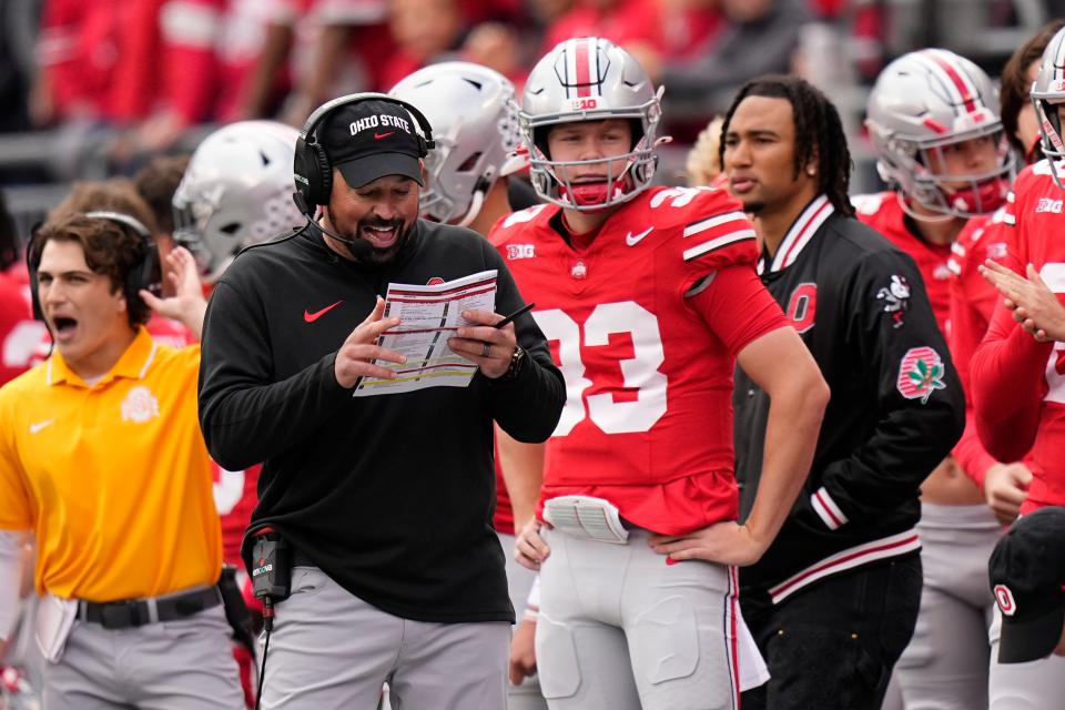 Oct 21, 2023; Columbus, Ohio, USA; Ohio State Buckeyes quarterback Devin Brown (33) stands behind head coach Ryan Day during the NCAA football game against the Penn State Nittany Lions at Ohio Stadium.