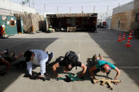 <p>A group of tourists do push-ups as they take part in a two hour “boot camp” experience, at “Caliber 3 Israeli Counter Terror and Security Academy” in the Gush Etzion settlement bloc south of Jerusalem in the occupied West Bank July 13, 2017. (Photo: Nir Elias/Reuters) </p>