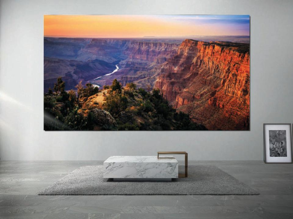 Samsung's massive The Wall MicroLED TV mounted in a minimalist living space. 