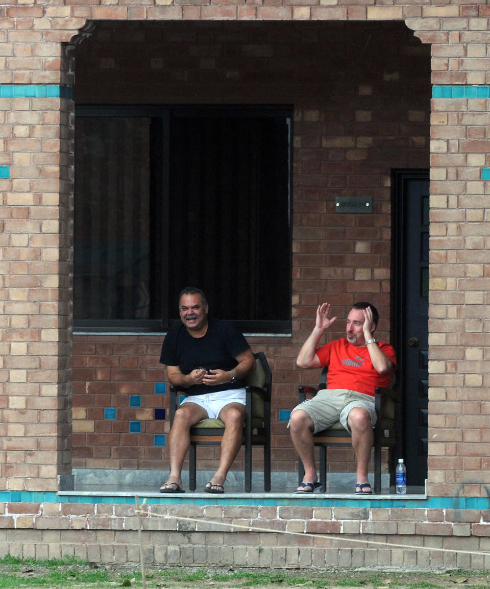 Pakistan's newly-appointed cricket team coach Dav Whatmore (L) and fielding coach Julien Fountain share a light moment at the Cricket Academy in Lahore on March 4, 2012. Former Australian batsman Dav Whatmore has been appointed Pakistan's head coach for two years replacing Mohsin Khan who was serving on an interim basis, officials said on March 4.