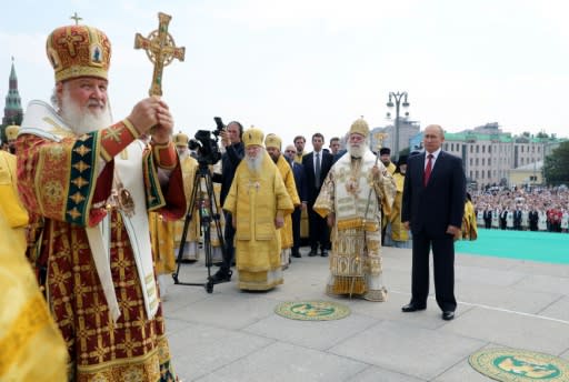 In Moscow, President Vladimir Putin headed a procession of worshippers with Russian Orthodox Patriarch Kirill, underlining their close relations