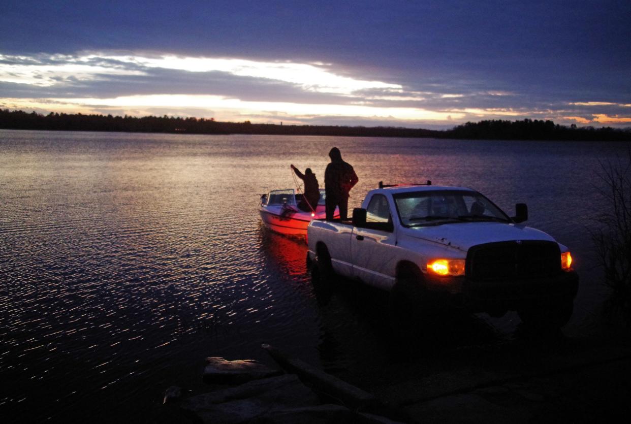 Jordan Romani (in boat) and Stephen Henderson, both from Taunton, bring in their boat after being out on Lake Nippenicket in Bridgewater for some fishing on Friday evening, April 19, 2024.They didn't have any luck, but they enjoyed the mild and sunny weather.