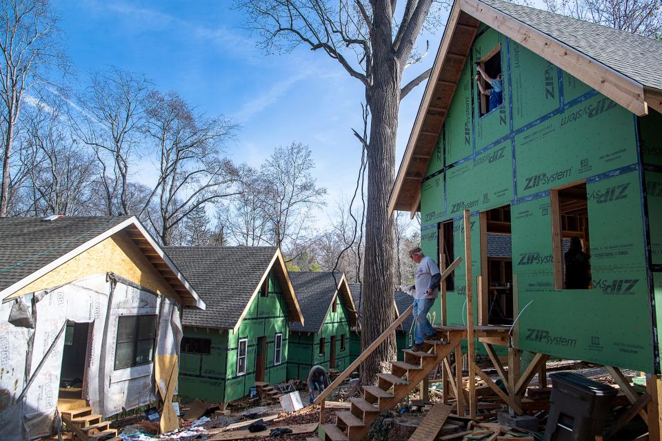 Volunteers work on the final stages of framing at the BeLoved Village, November 14, 2023, in Asheville.