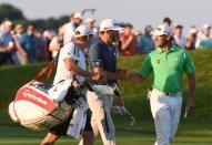 Jun 19, 2016; Oakmont, PA, USA; Dustin Johnson (middle) is congratulated by Lee Westwood (right) after Johnson's fairway shot on the 18th hole during the final round of the U.S. Open golf tournament at Oakmont Country Club. Mandatory Credit: Kyle Terada-USA TODAY Sports