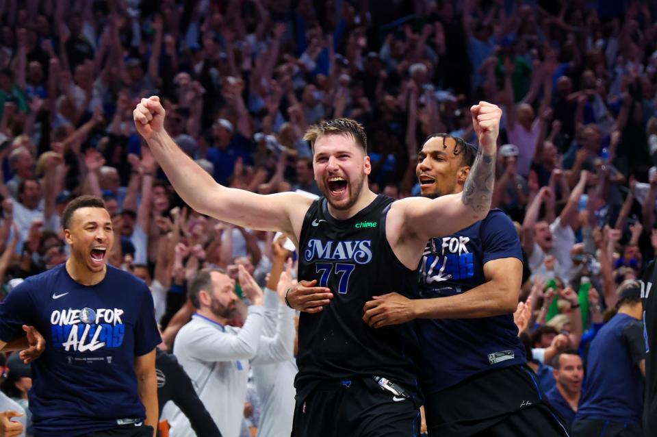 Dallas Mavericks guard Luka Doncic (77) celebrates with teammates after their win against the Oklahoma City Thunder in Game 6.