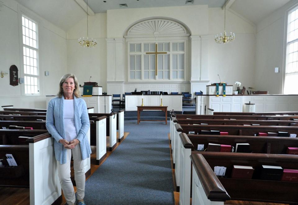 Church moderator Kathi Blair stands in the sanctuary of Hingham Congregational Church, which is celebrating its 175th anniversary. Thursday, June 8, 2023.