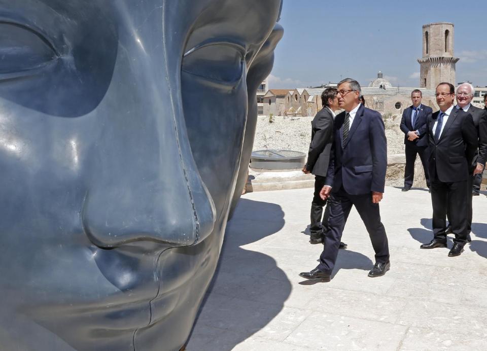 French President Francois Hollande, right, with MuCEM president Suzzarelli, center, seen during his visit to the Museum of Civilizations from Europe and the Mediterranean (MuCEM) in Marseille, southern France, Tuesday June 4, 2013. The museum that cost over 200 million euros ($260 million), was inaugurated by French President Francois Hollande on Tuesday, and is the center piece of Marseille's turn as the European Capital of Culture for 2013, which aims to attract 10 million visitors this year. (AP Photo/Jean-Paul Pelissier, Pool)