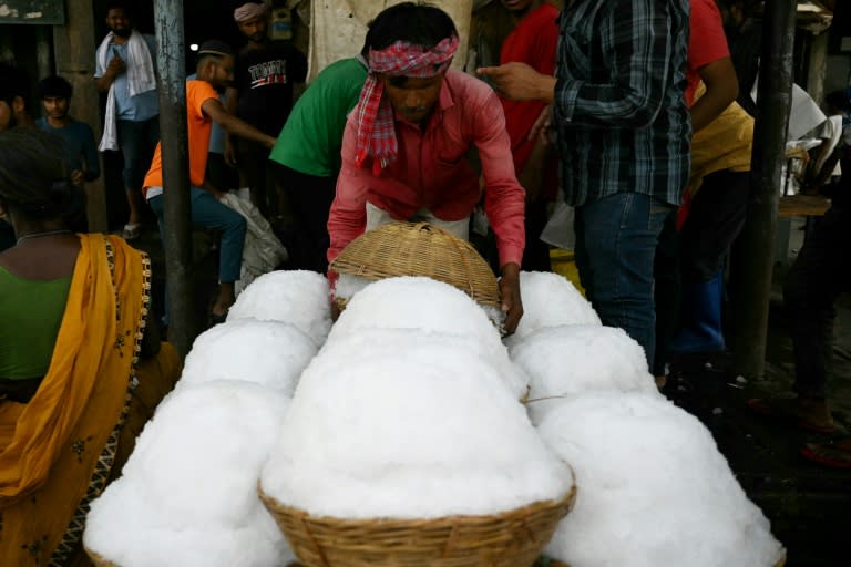 Un trabajador transfiere cestas de hielo raspado a un procesador de alimentos en un mercado de Nueva Delhi el 29 de mayo de 2024, en plena ola de calor (Arun Sankar)