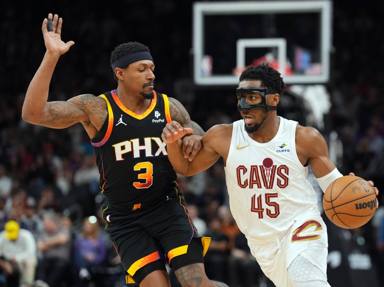 Cleveland Cavaliers guard Donovan Mitchell (45) dribbles against Phoenix Suns guard Bradley Beal (3) during the second half at Footprint Center in Phoenix on April 3, 2024.