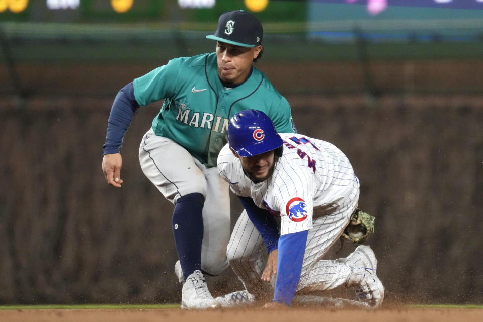 Seattle Mariners second baseman Kolten Wong tags out Chicago Cubs' Nick Madrigal during the sixth inning of a baseball game in Chicago, Tuesday, April 11, 2023. (AP Photo/Nam Y. Huh)