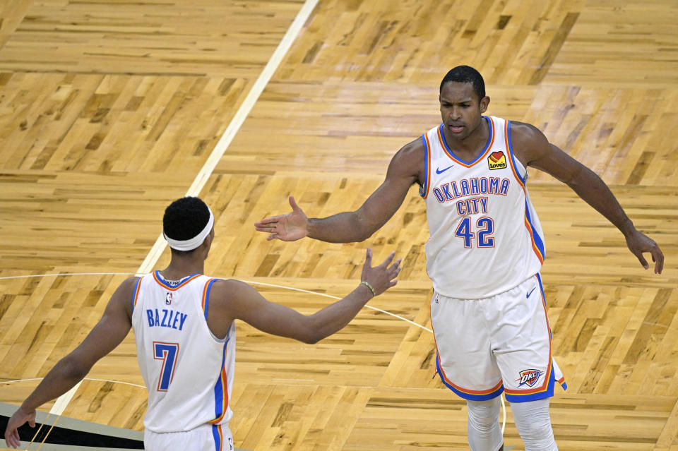Oklahoma City Thunder center Al Horford (42) is congratulated by forward Darius Bazley (7) after Horford made a 3-point basket during the second half of an NBA basketball game against the Orlando Magic, Saturday, Jan. 2, 2021, in Orlando, Fla. (AP Photo/Phelan M. Ebenhack)