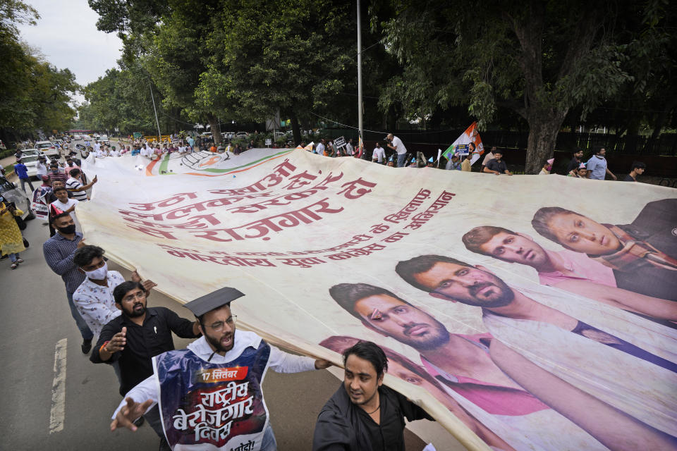 Indian Youth Congress members carry a giant banner during a protest held to mark Indian Prime Minister Narendra Modi's birthday in New Delhi, India, Friday, Sept.17, 2021. Youth members of main opposition Congress party clashed with police during a street protest Friday demanding jobs as the country’s economy recovered from the impact of the COVID-19 pandemic that triggered massive unemployment in the country. The march took place as supporters of Prime Minister Narendra Modi celebrated his birthday as he turned 71 on Friday. (AP Photo/Manish Swarup)