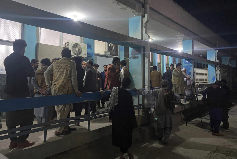 Relatives wait outside a hospital for the bodies of three women that ware killed by gunmen in the city of Jalalabad east of Kabul, Afghanistan, Tuesday, March 2, 2021. The women who worked for a local radio and TV station in eastern Afghanistan were gunned down Tuesday in two separate attacks, the news editor of the privately owned station said. (AP Photo/Sadaqat Ghorzang)