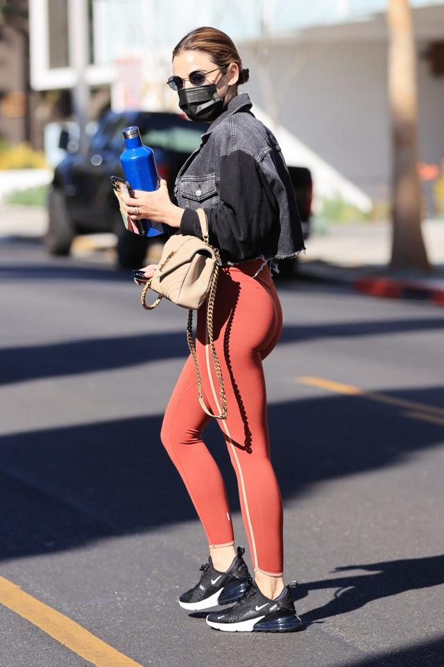 Hilary Duff looks fierce in red leggings and a white top while