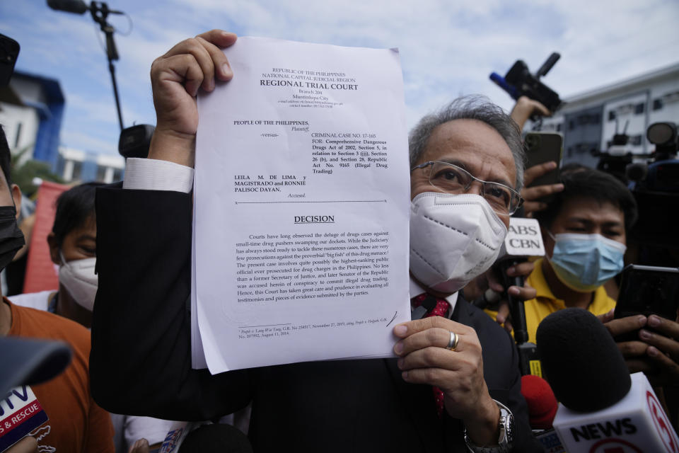 Lawyer Boni F. Tacardon holds the decision on detained former opposition Senator Leila de Lima outside the Muntinlupa trial court on Friday, May 12, 2023 in Muntinlupa, Philippines. De Lima was acquitted by the Muntinlupa court in one of her drug related charges she says were fabricated by former President Rodrigo Duterte and his officials in an attempt to muzzle her criticism of his deadly crackdown on illegal drugs. (AP Photo/Aaron Favila)